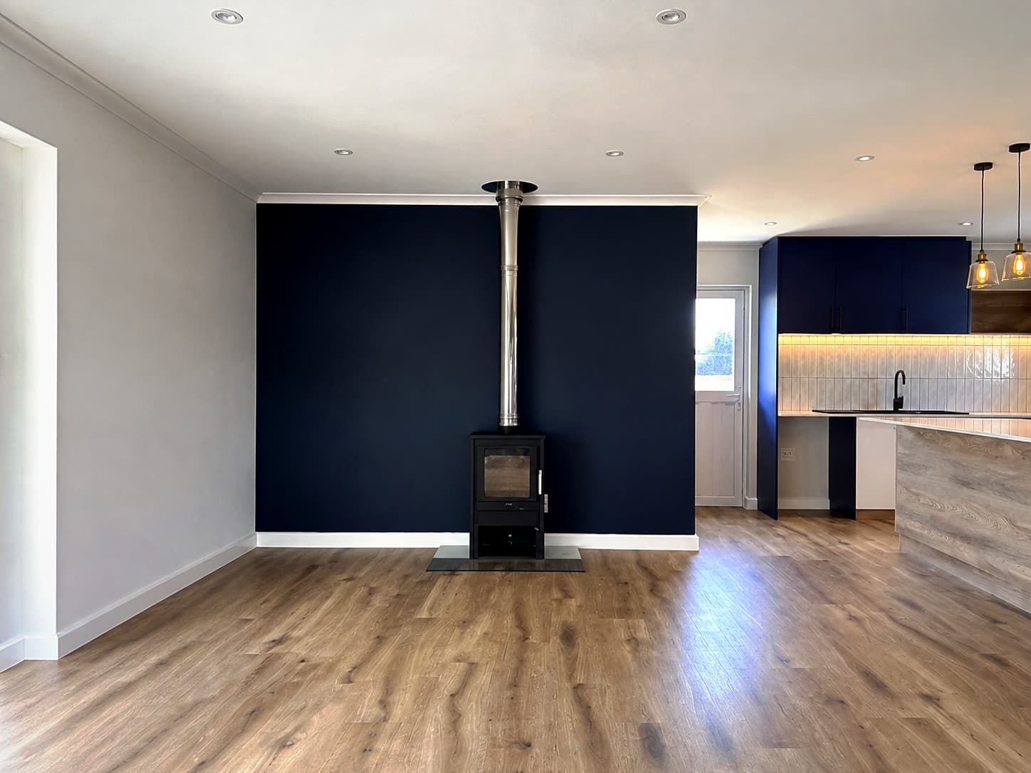 Bloubergstrand – Elevation of the navy wall with the black stove and flue
