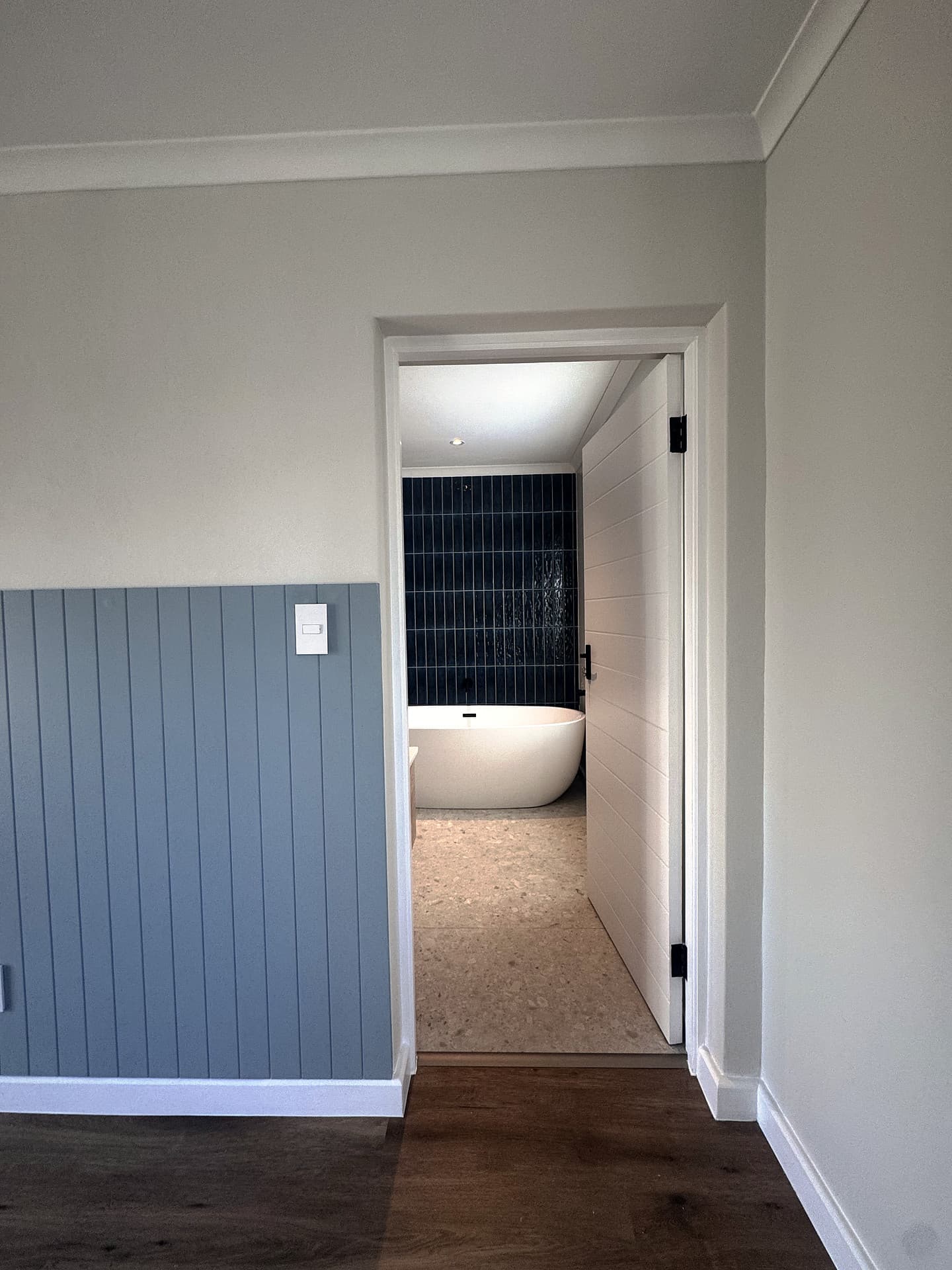 Bloubergstrand – Corridor with blue panelling leading to the main bathroom