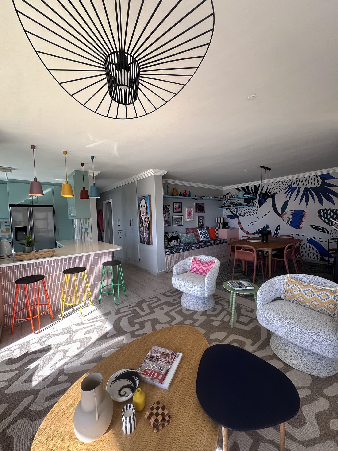 Strand – From the sofas across to the kitchen island under the wire pendant