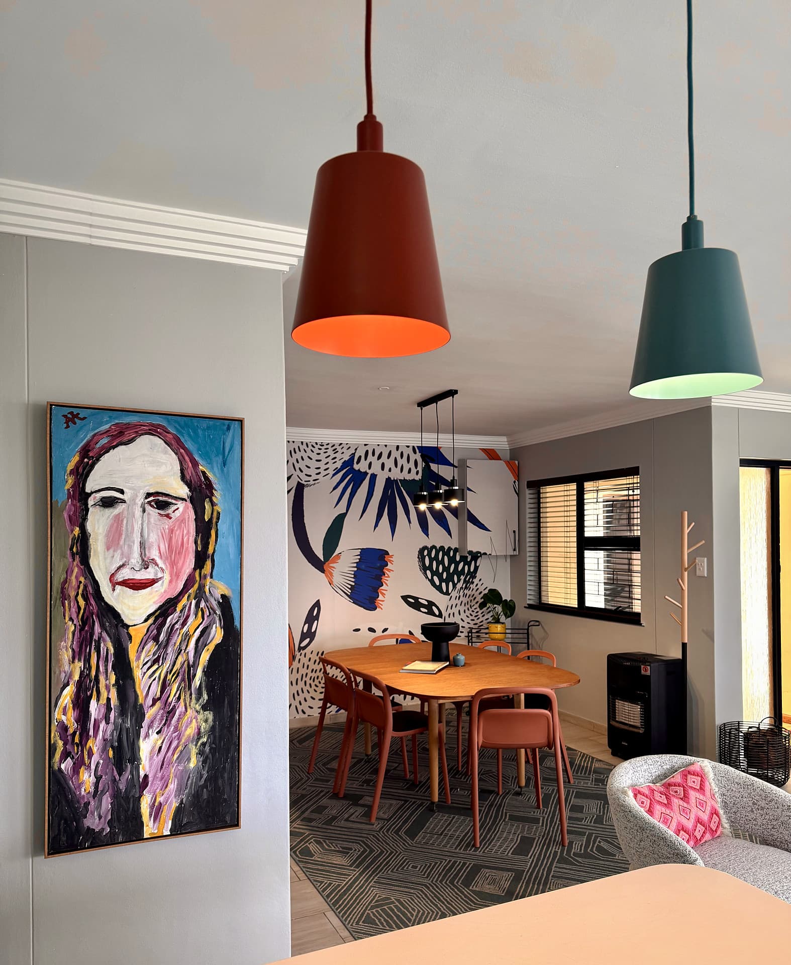 Strand – Portrait painting with the dining area beyond, two pendants