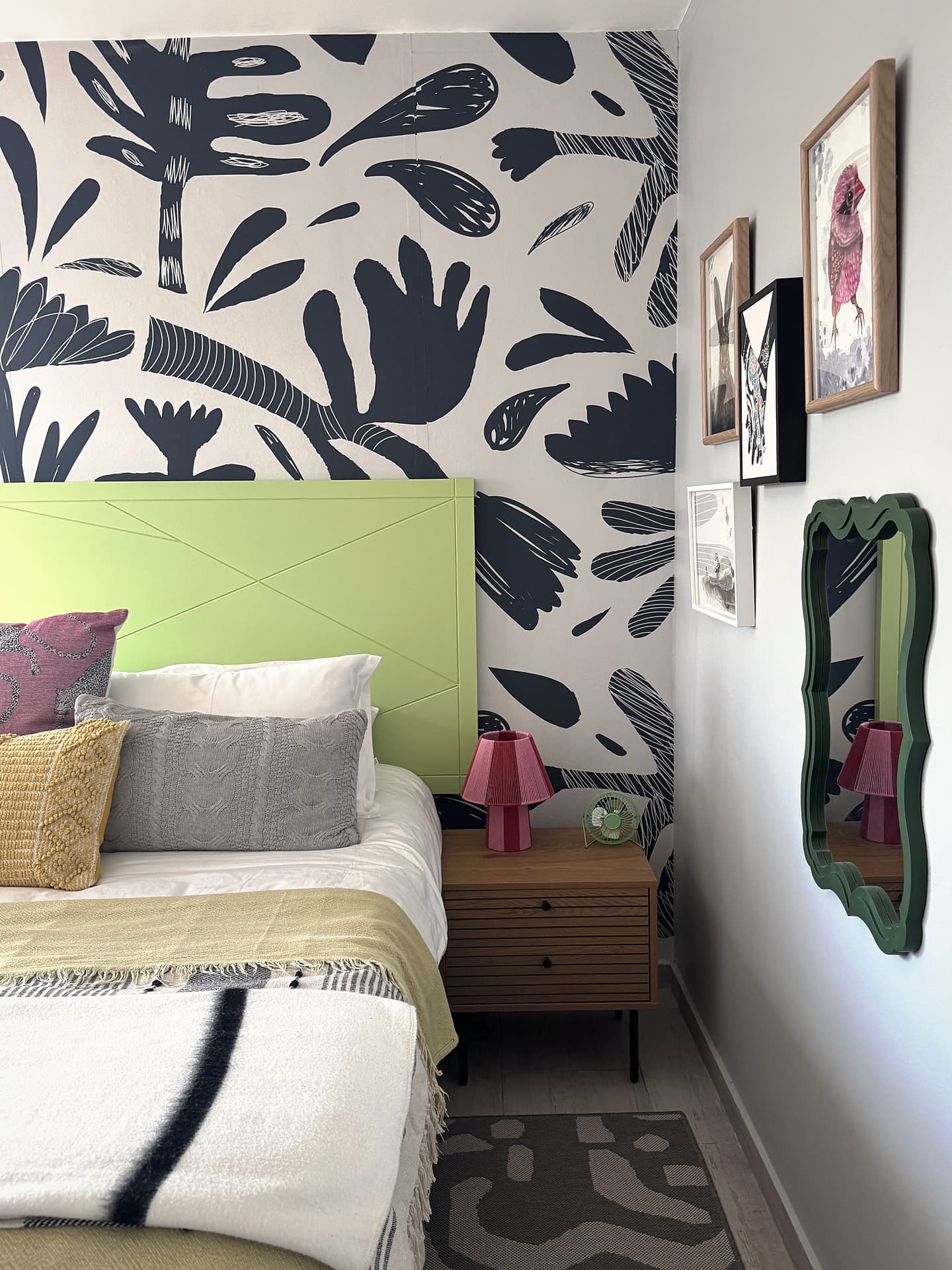 Strand – Green headboard, navy leaf mural and a wavy mirror