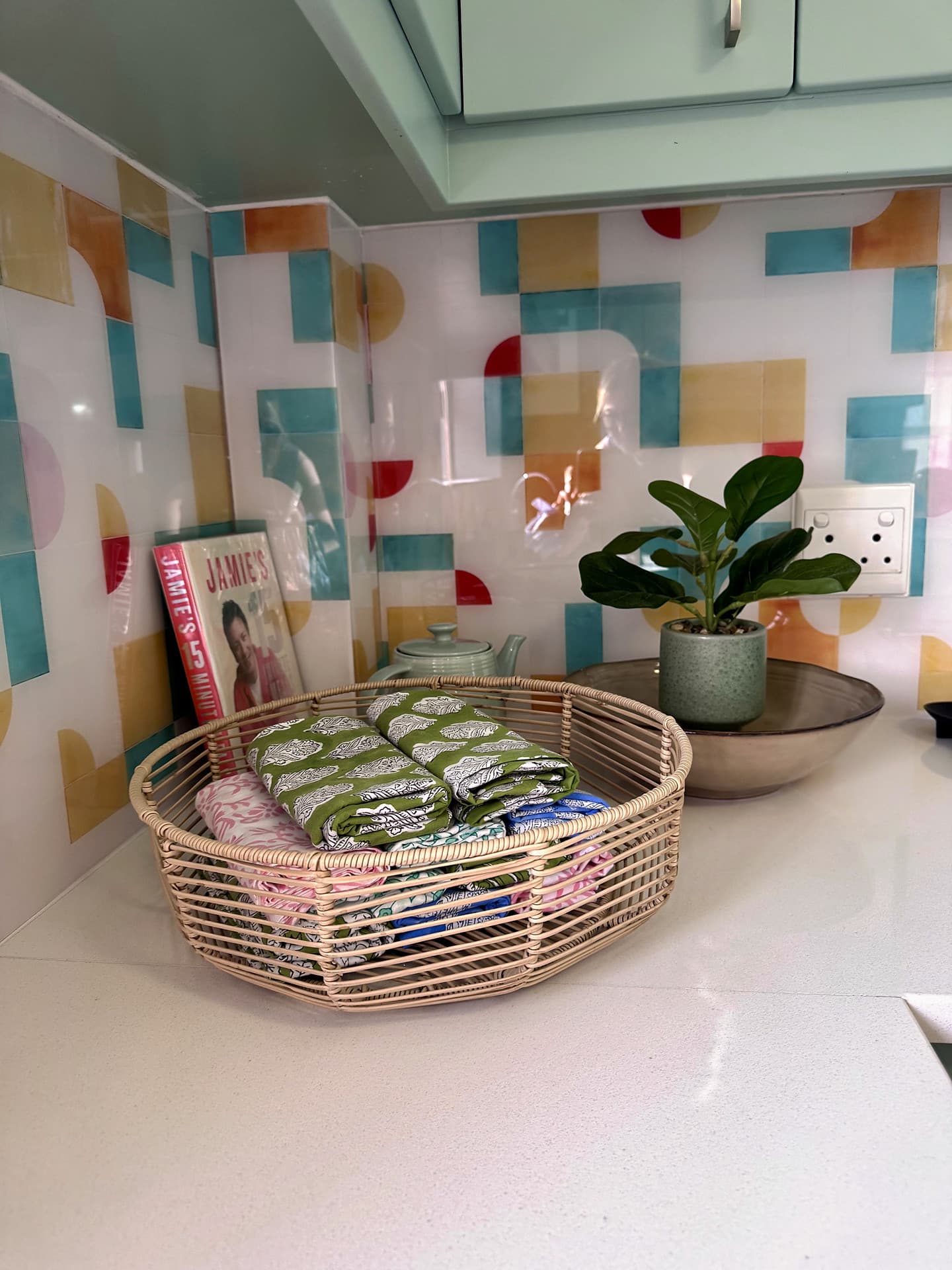 Strand – Patterned splashback with a rattan basket and a plant on the counter