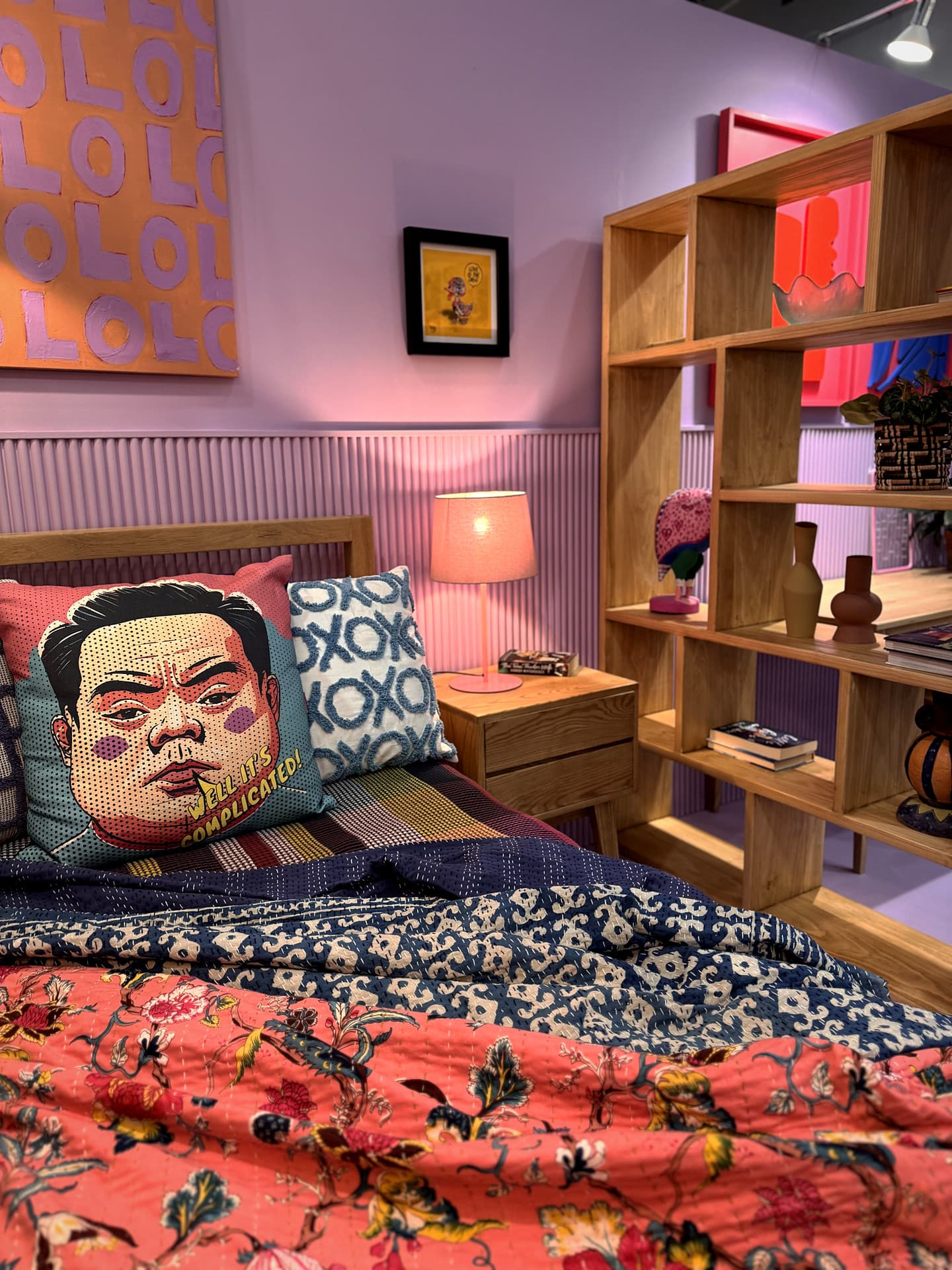 Urban Living Pod – Bed detail: quilt, cushions and the shelving beside it