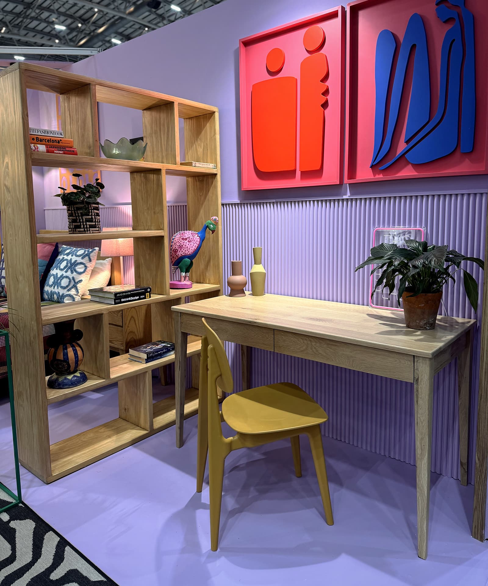Urban Living Pod – Desk and chair beneath relief artworks