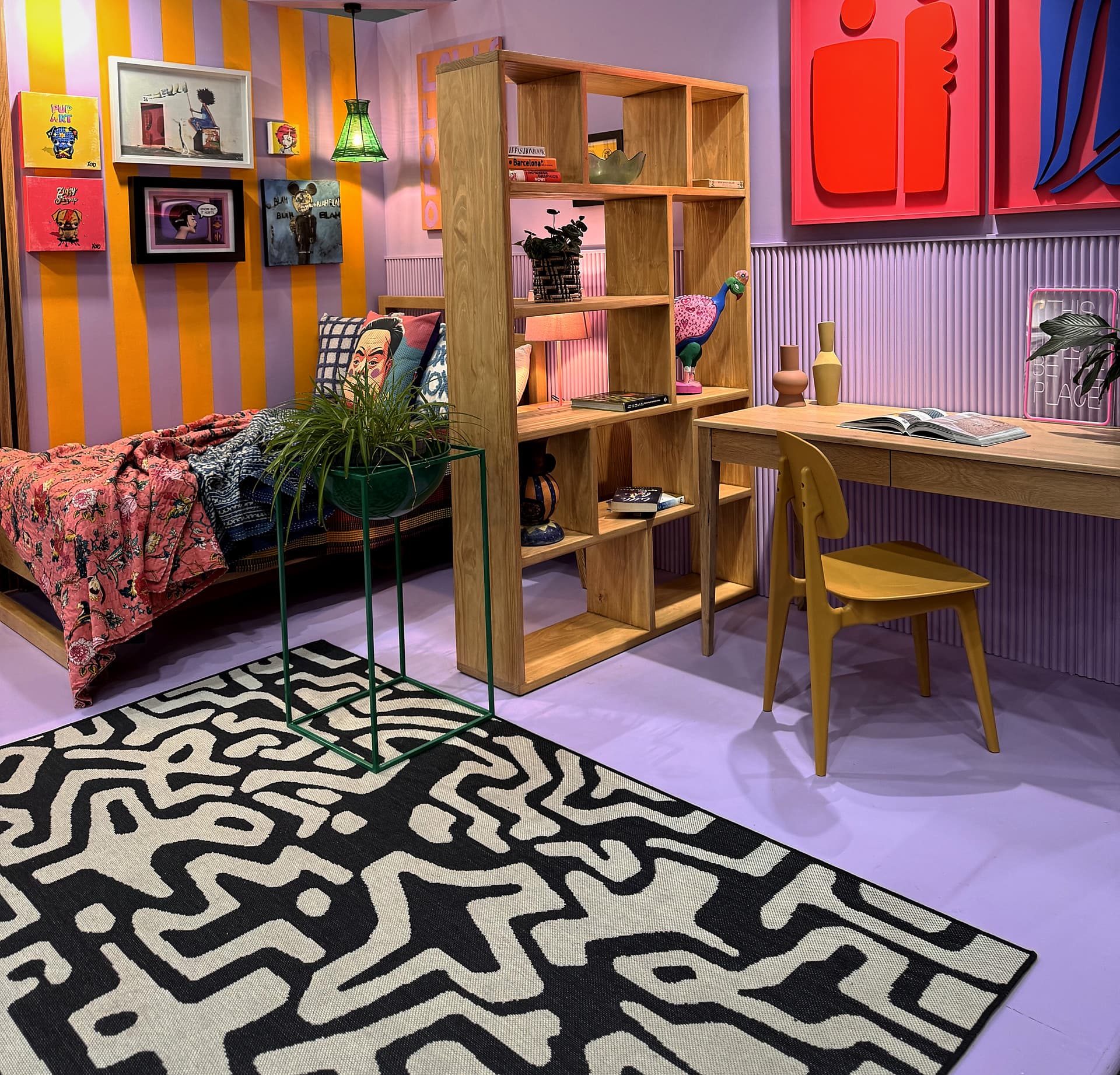 Urban Living Pod – The pod seen from the rug: bed, oak shelving unit and desk under the striped walls