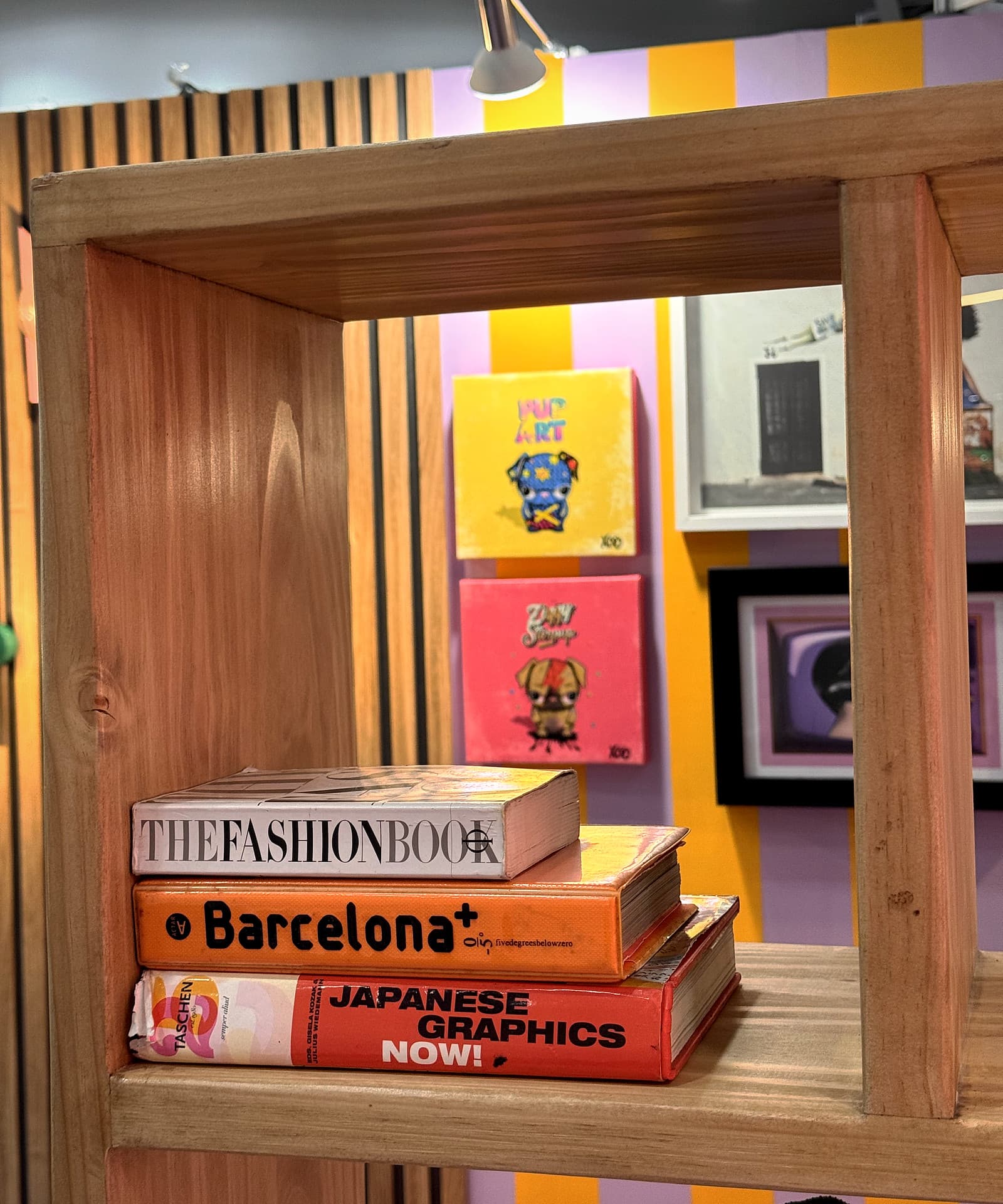 Urban Living Pod – Books on the shelf with artworks beyond